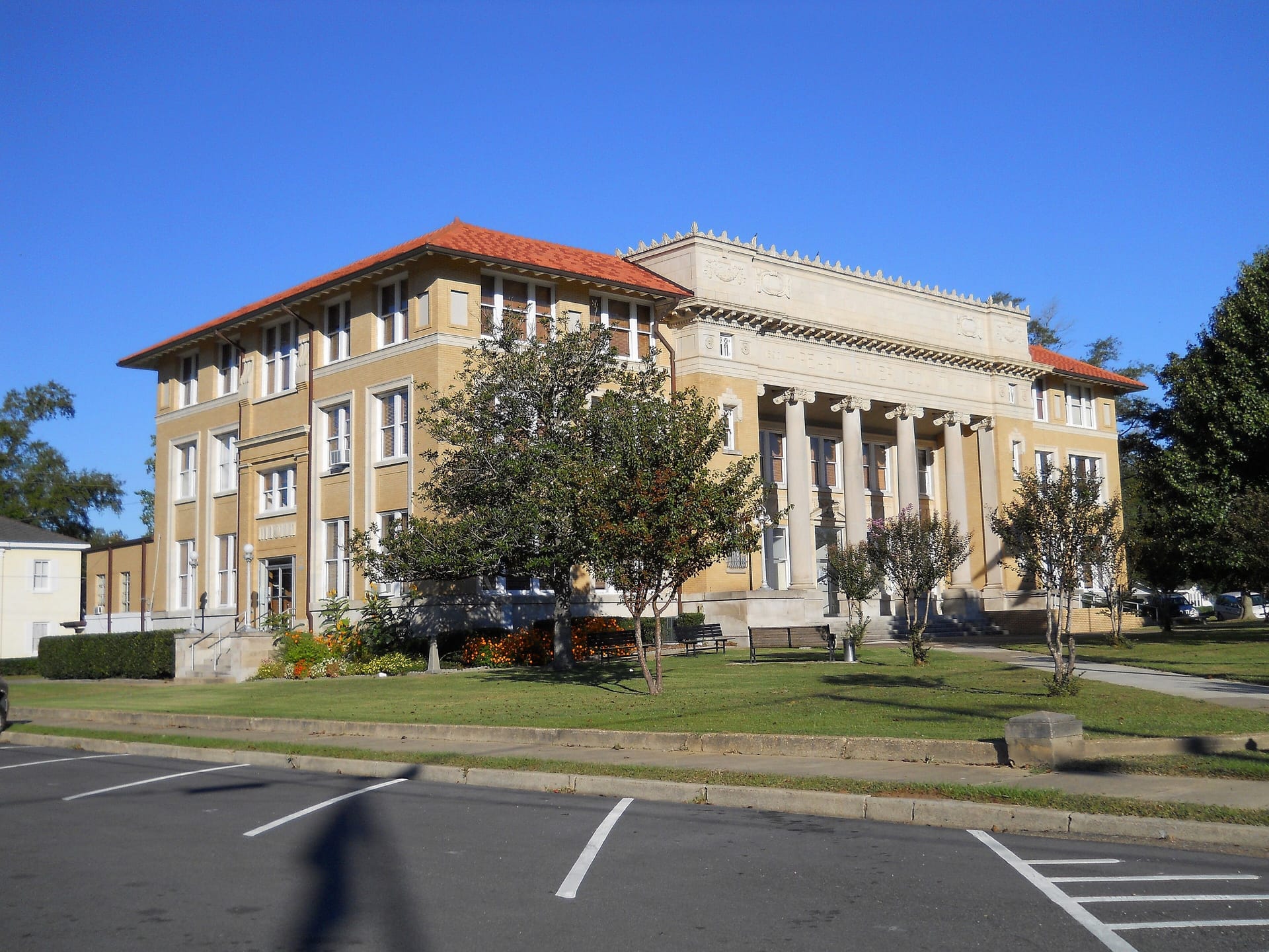 The Pearl River County Courthouse in Poplarville, a yellow-brick building with a tiled roof and Ionic columns.
